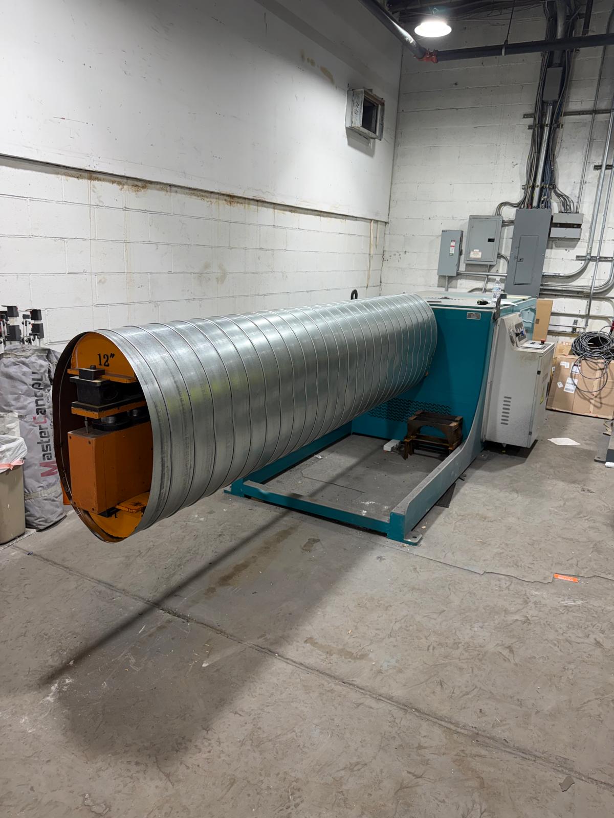 Large oval duct being formed on a fabrication machine, end view