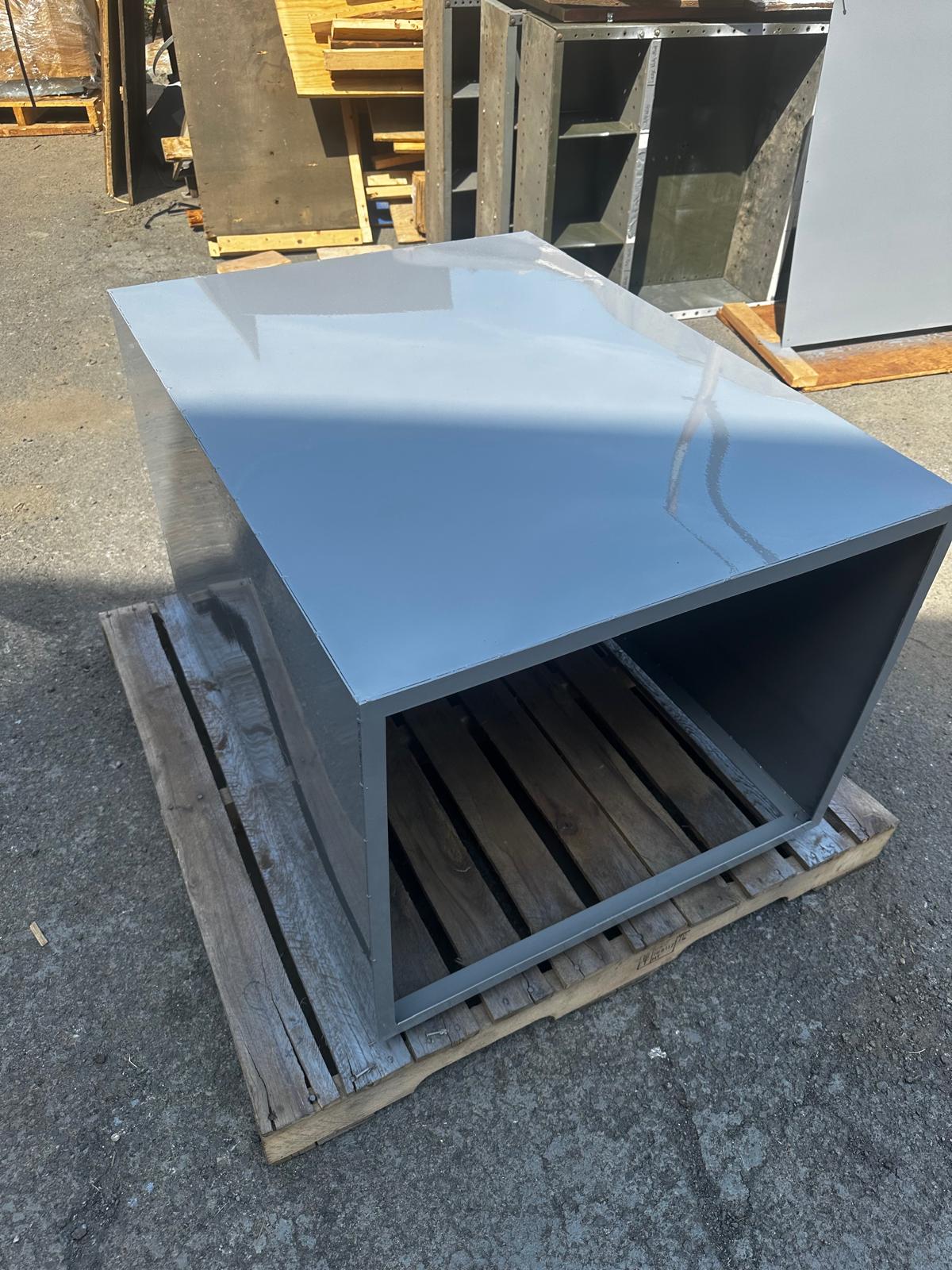 Large fabricated gray metal enclosure on a pallet