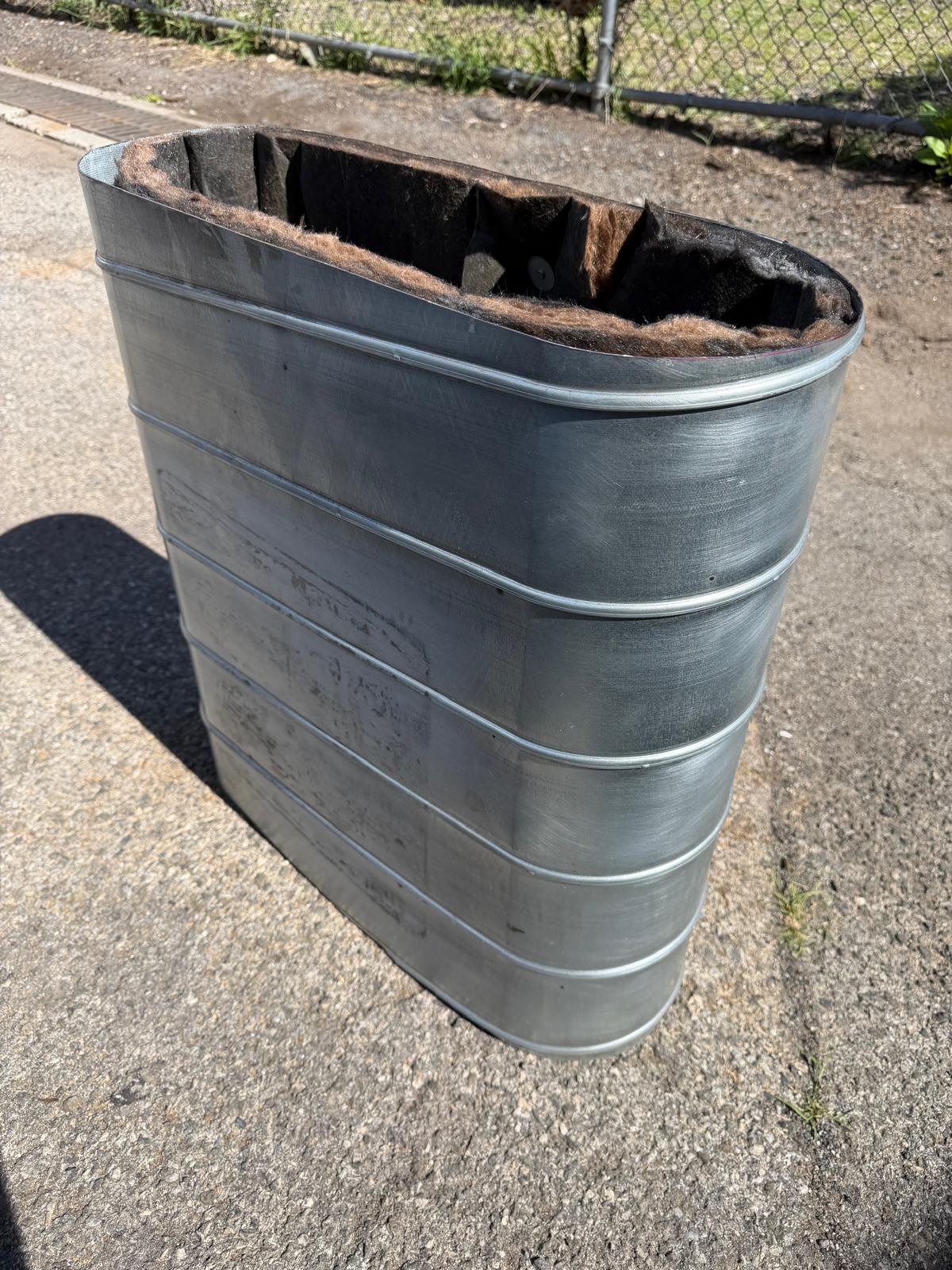 Oval duct section with dark interior lining visible