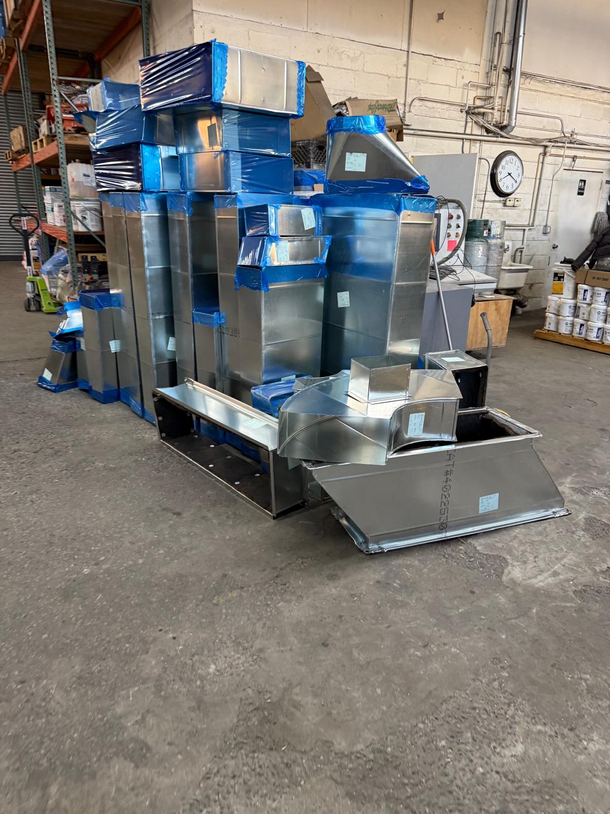 Fabricated ductwork and fittings of different shapes and sizes in the shop